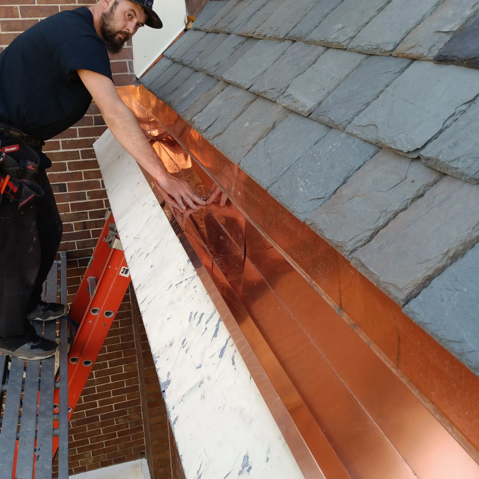 Copper flashing installation on slate church roof by DG Builders