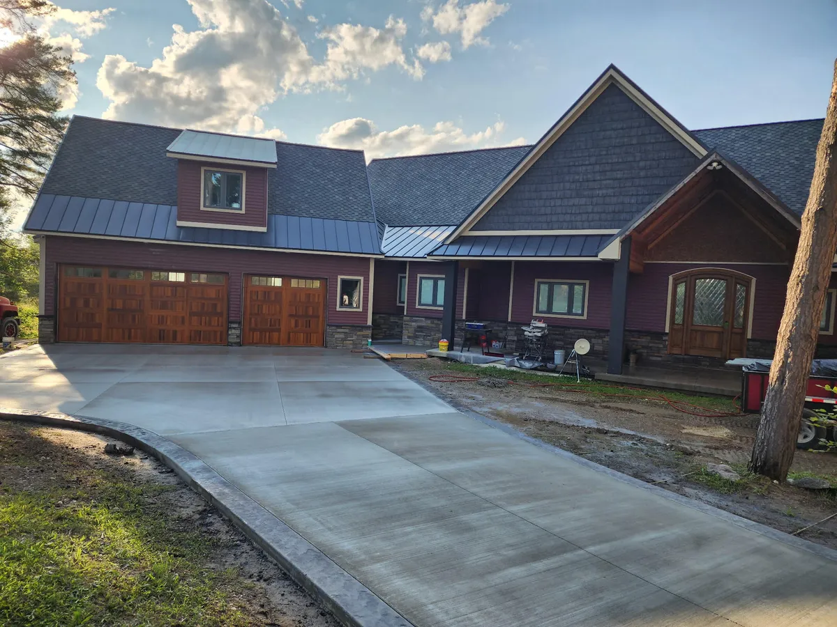 Custom home build with metal roof and stone accents by DG Builders LLC in Genesee County Michigan