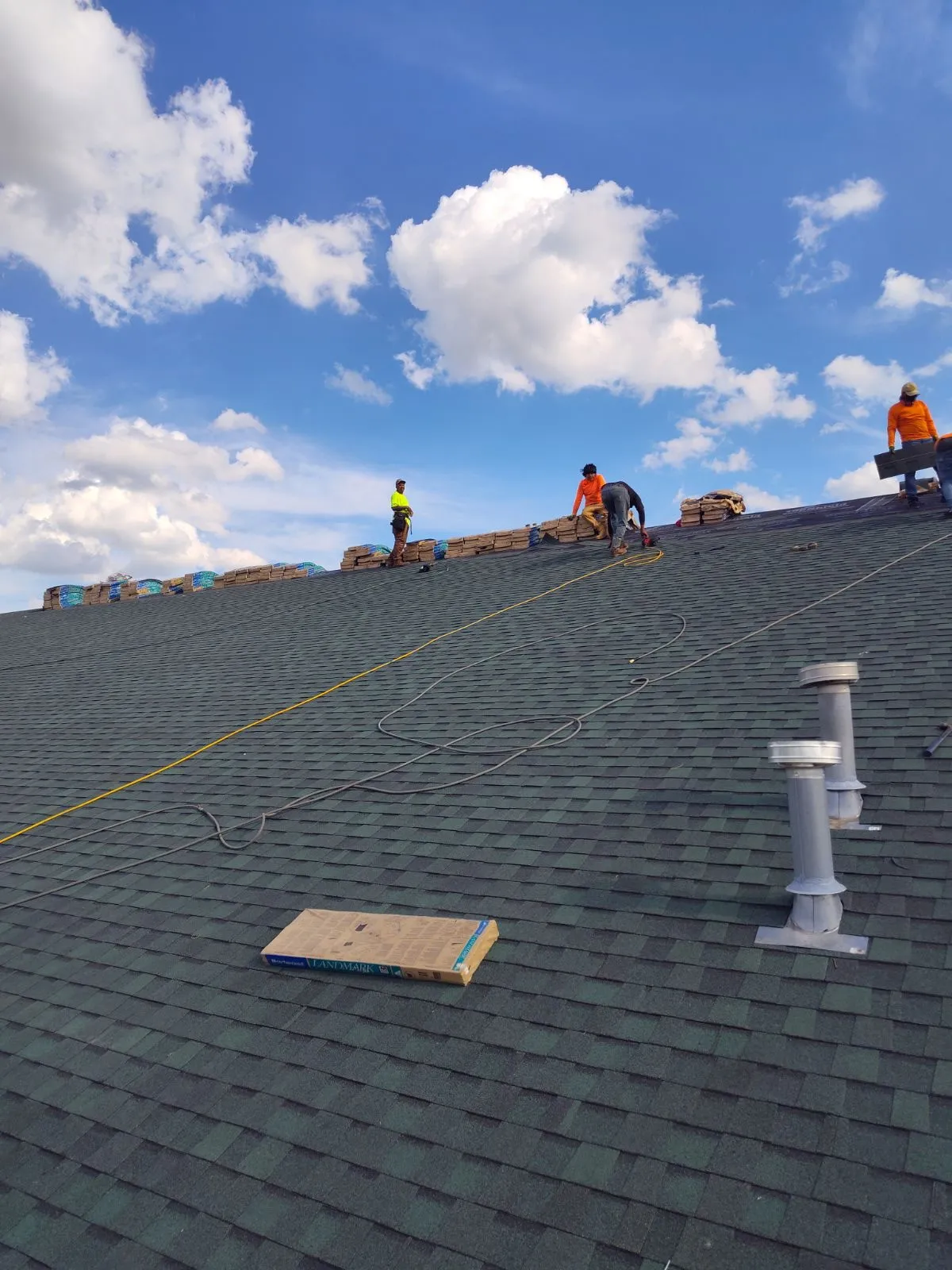 DG Builders roofing crew installing shingles on residential home in Saginaw County Michigan
